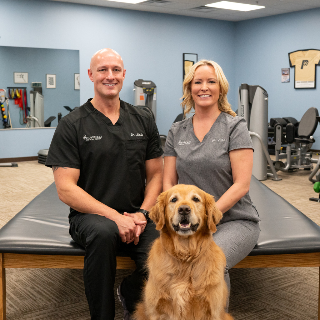 Dr. Mark and Dr. Kara of BodyWorks Medical Center with their golden retriever